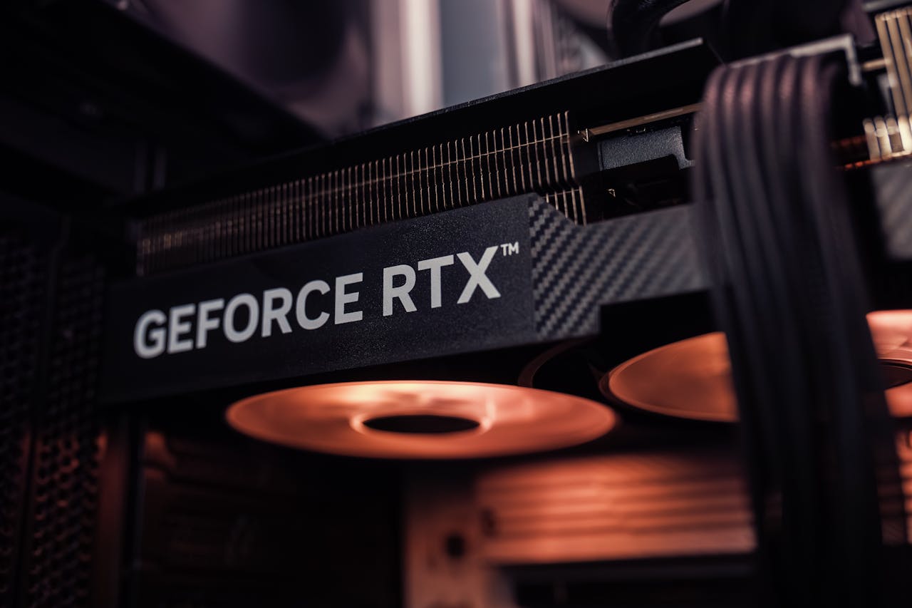 GeForce RTX graphics card installed inside a PC, glowing under warm lighting.